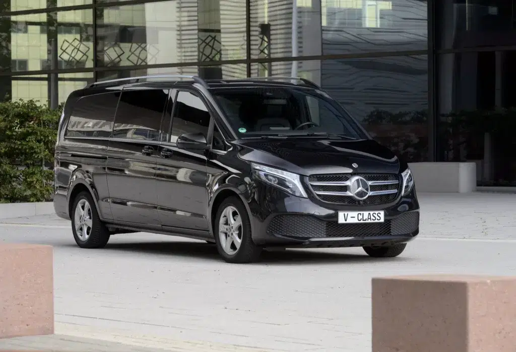 A black Mercedes V-Class van with chauffeur from a limousine service in frankfurt.