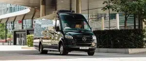 A black Mercedes Sprinter coach ready for pick up of vip passengers at the Frankfurt trade fair.