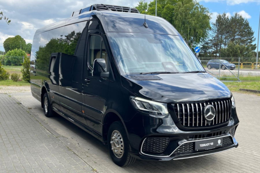 A large black Mercedes Benz VIP Sprinter bus that allows up to 16 passengers to travel very comfortably and conveniently.